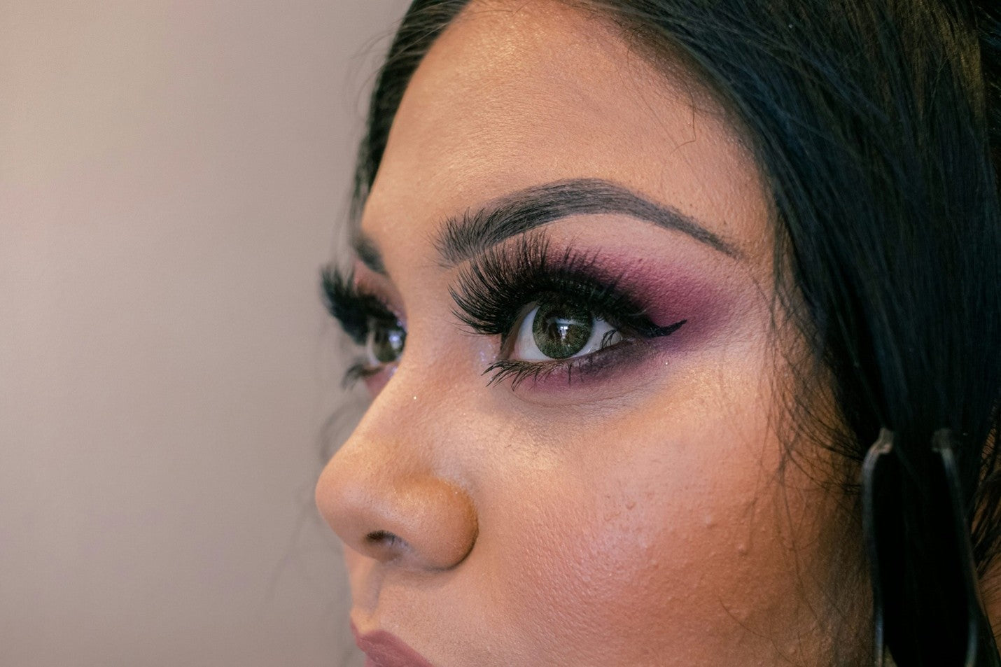 Close-up of a woman's face showing cakey foundation near the nose.